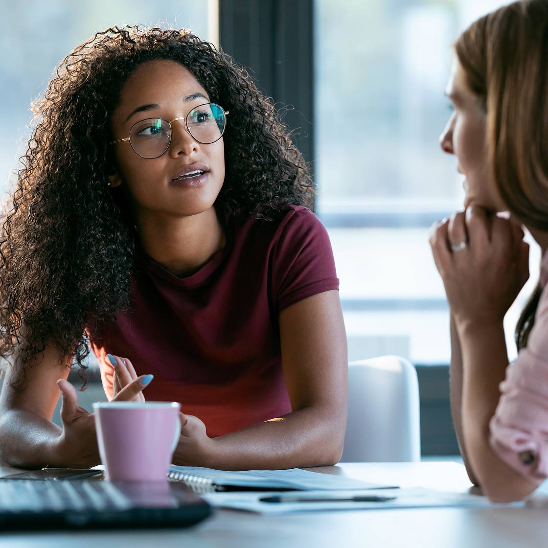 women chatting in office
